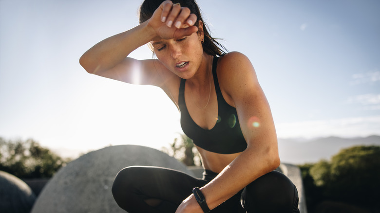 Woman wiping sweat from her brow