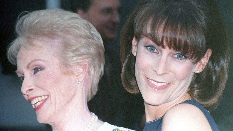 Janet Leigh and Jamie Lee Curtis smiling, looking in opposite directions