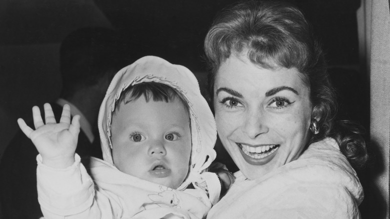 Janet Leigh smiles holding her baby daughter Jamie Lee Curtis in her arms, United States, circa 1959.