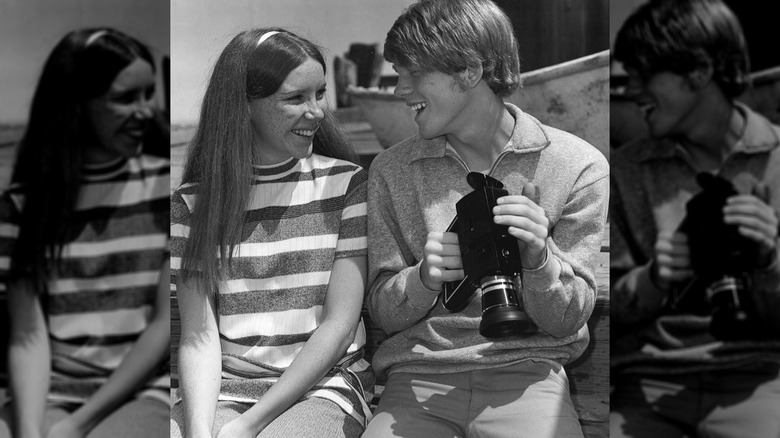 Cheryl Alley and Ron Howard look at each other and smile in a behind the scenes photo from the set of The Smith Family