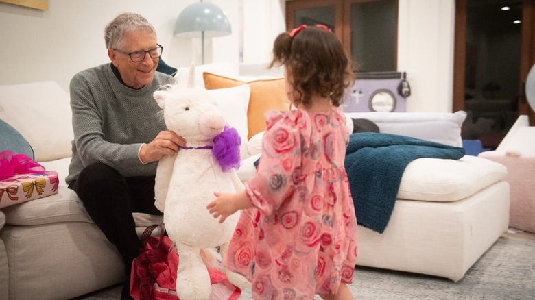 Bill Gates gives Leila a stuffed unicorn