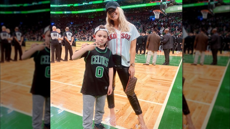 Karoline Leavitt poses with her godson at a Celtics game in April 2022.