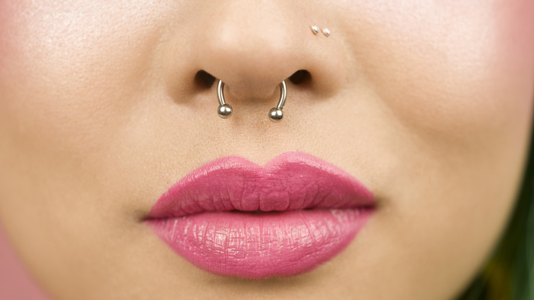 Woman with septum and nostril piercings