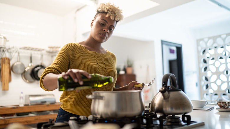 Woman holding a glass of olive oil