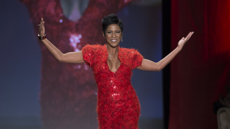 Tamron Hall modeling red gown