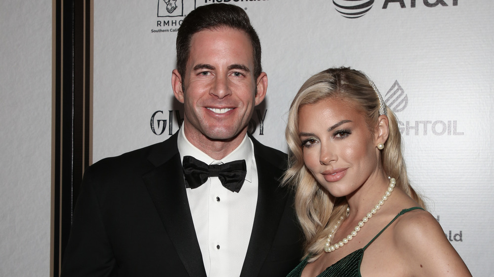 Tarek El Moussa posing with Heather Rae Young