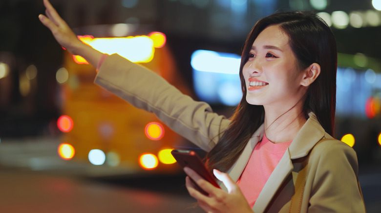 woman trying to hail a cab