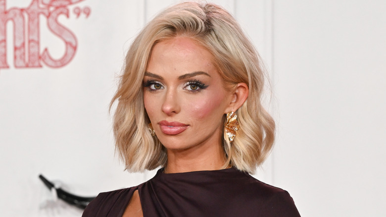 Miranda McWhorter posing at an event in a brown dress