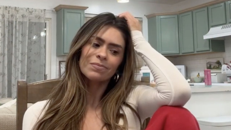 Taylor Frankie Paul with a hand on her head for an Instagram reel