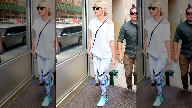 Taylor Swift wearing patterned leggings and white T-shirt.
