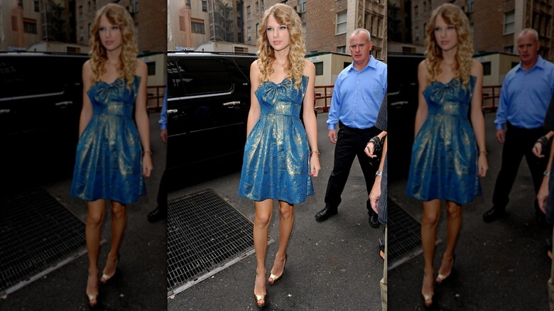 Taylor Swift wearing a sparkly dress with a bow on the bust.