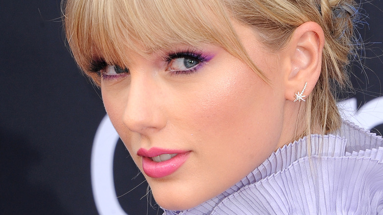 Taylor Swift looking sideways in purple
