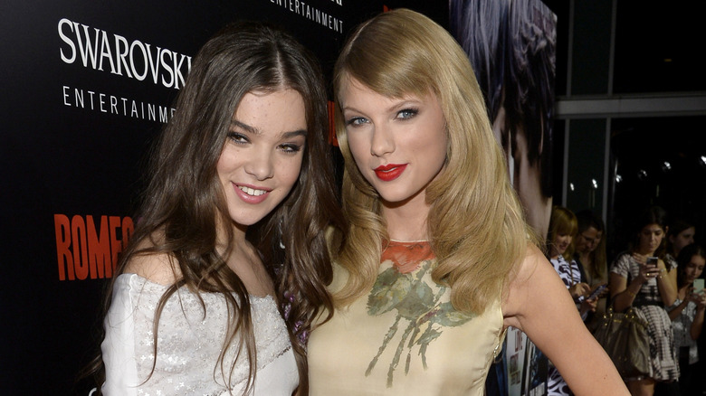 Hailee Steinfeld poses with Taylor Swift at an event