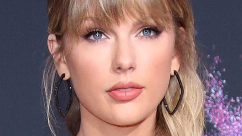 Taylor Swift with bangs and slight smile