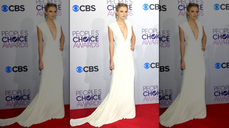 Taylor Swift poses in white dress