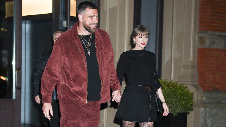 Travis Kelce and Taylor Swift holding hands