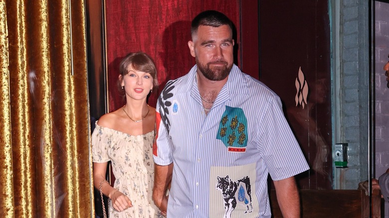 Taylor Swift and Travis Kelce hold hands