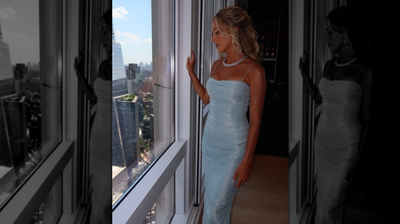Brittany Mahomes, in her baby blue dress, looking out of the window