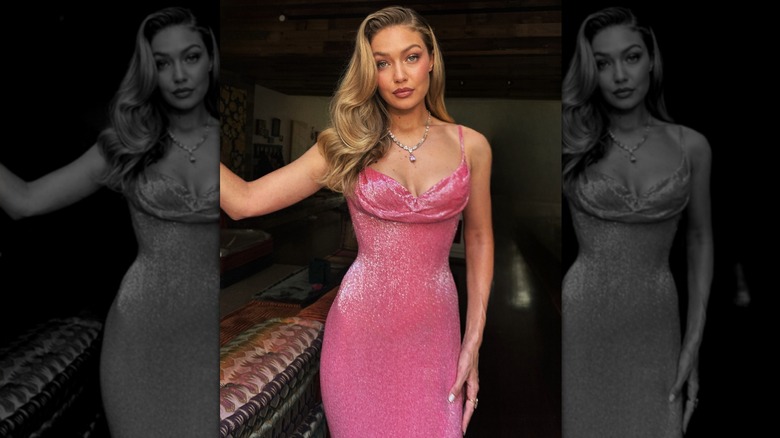 Gigi Hadid smizing in a sparkling pink dress