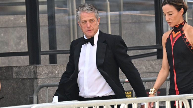 Hugh Grant entering Madison Square Garden with his wife, Anna Elisabet Eberstein, by his side