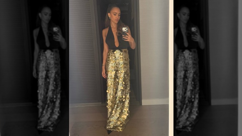 Jessica Alba takes a mirror selfie in her black and gold dress