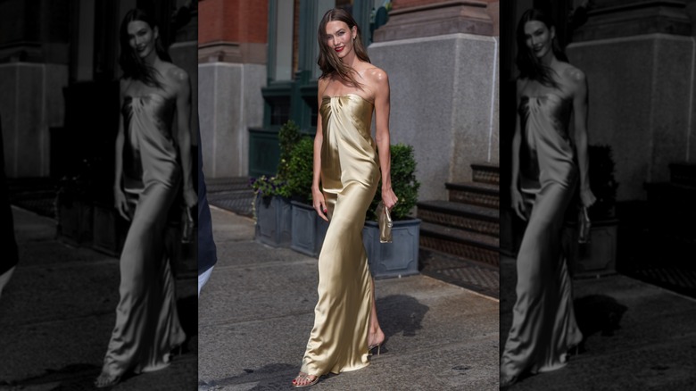 Karlie Kloss walking on a New York street in her gold dress