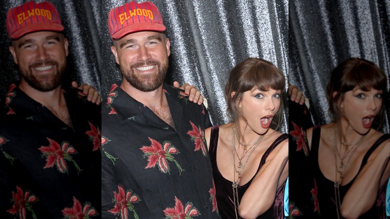 Travis Kelce and Taylor Swift smile together in front of a silver curtain