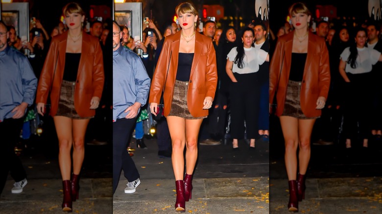 Taylor Swift in an orange leather jacket and a skirt with red boots