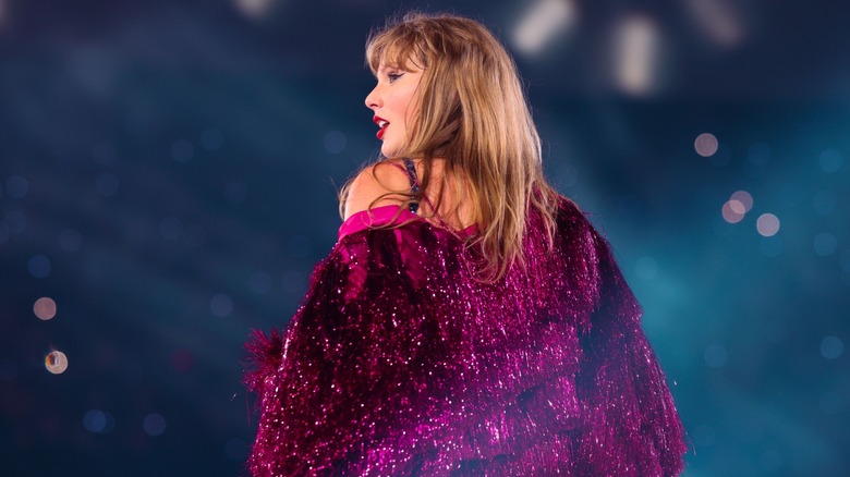 Taylor Swift with her back to the camera on stage during the Eras tour
