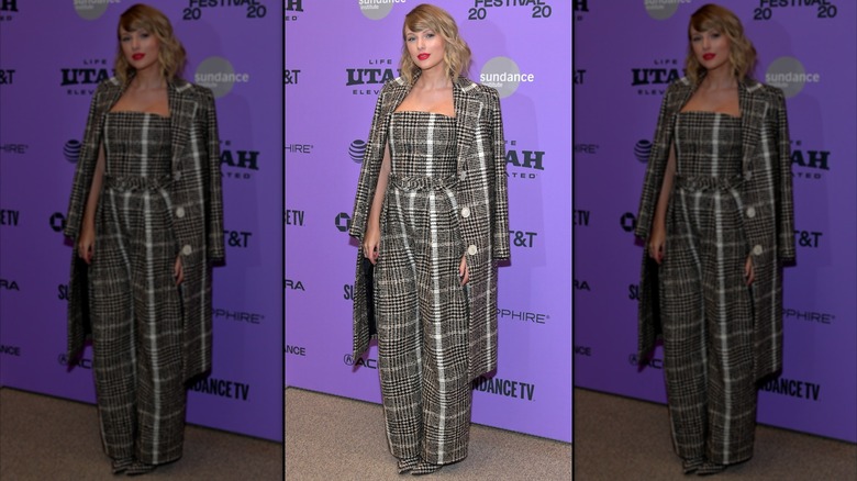 Taylor Swift in a gray print suit and matching coat at an event