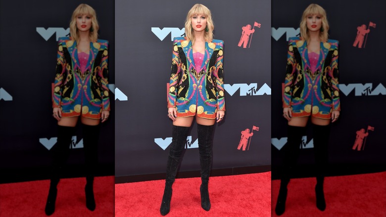 Taylor Swift in a bright blazer print dress and thigh-high boots at the 2019 MTV Awards