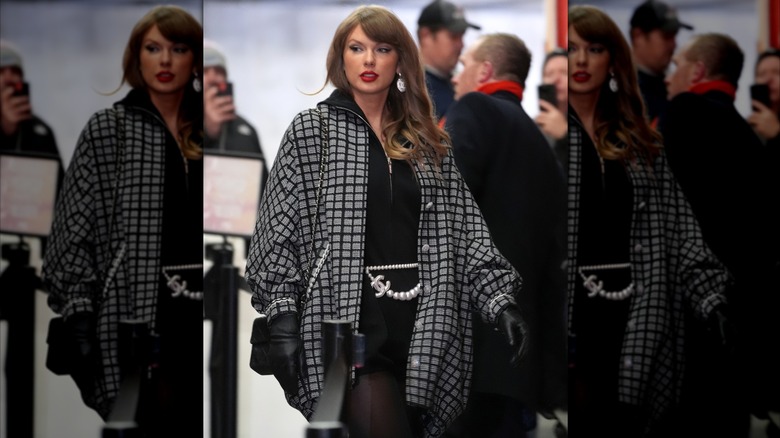 Taylor Swift in a gray coat and a black dress with pearl jewels