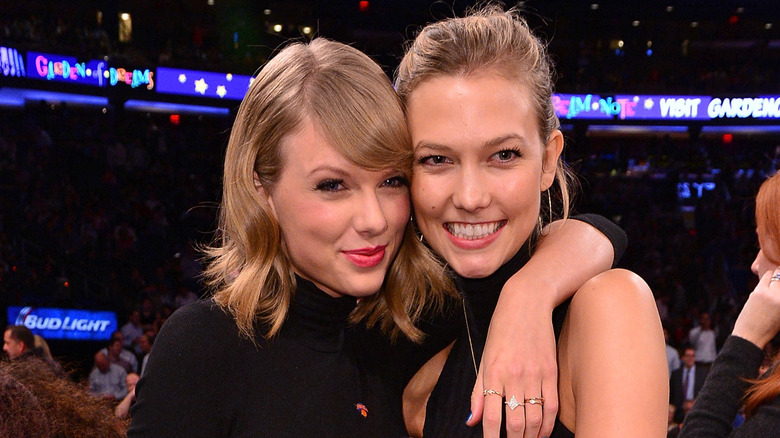 Taylor Swift and Karlie Kloss hugging at an event