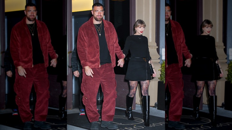 Travis Kelce holding hands with Taylor Swift