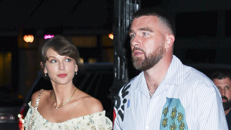 Taylor Swift looking up at Travis Kelce as they walk together in New York City on May 15, 2026