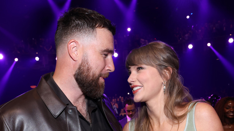 Taylor Swift and Travis Kelce looking lovingly at each other at the 2026 iHeartRadio Music Awards