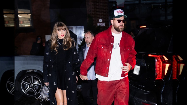 Taylor Swift walking hand in hand with Travis Kelce on the streets.