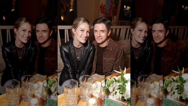 Ashley and Topher Grace sitting closely and smiling for cameras in early 2026