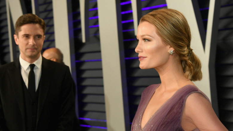 Topher Grace watching his wife Ashley pose for photos at the 2019 Vanity Fair Oscars after-party