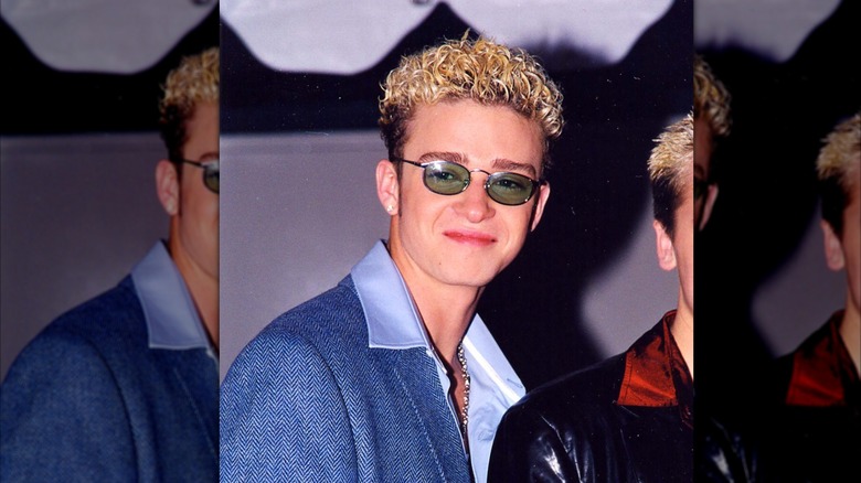 Justin Timberlake smiles in sunglasses and blue jacket