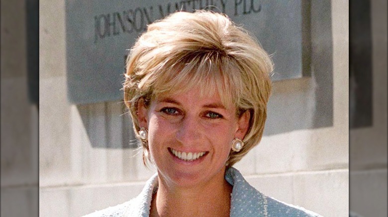 Princess Diana smiles with pearl earrings