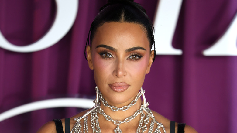 Kim Kardashian at a premiere in London with a thick chain around her neck