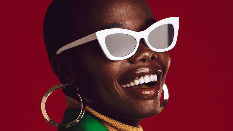 Woman wearing red heart-shaped sunglasses