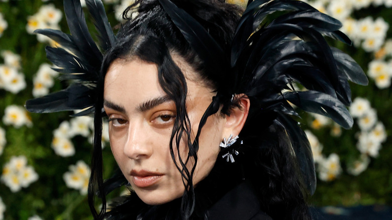 Charli XCX wearing feather headdress