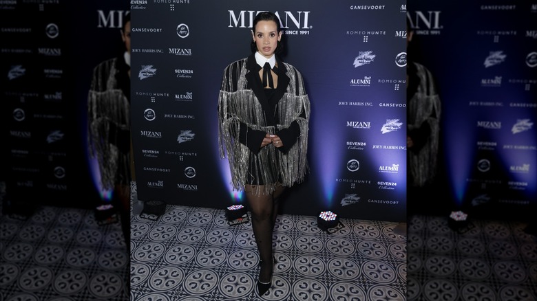 Dascha Polanco posing in a black jacket with silver fringe