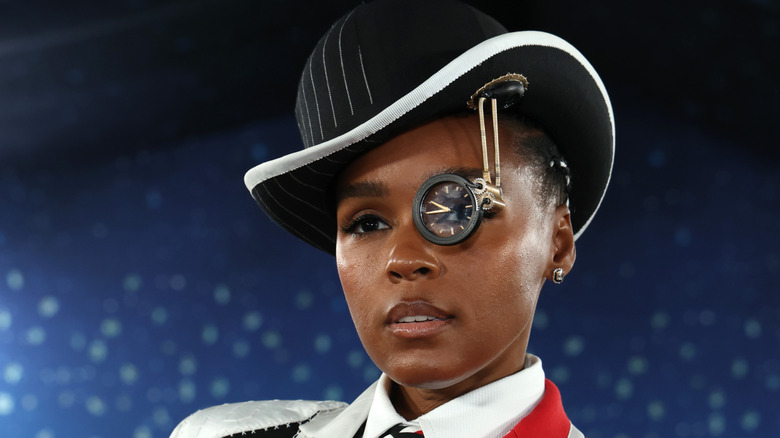 Janelle Monae wearing a hat and monocle