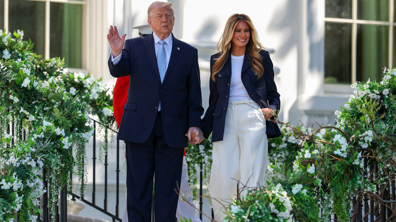 Donald and Melania Trump holding hands