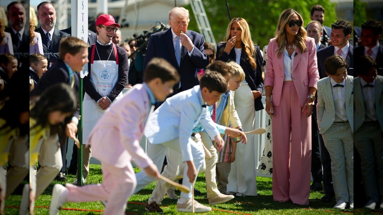 Donald, Melania, and Lara Trump standing in a crowd