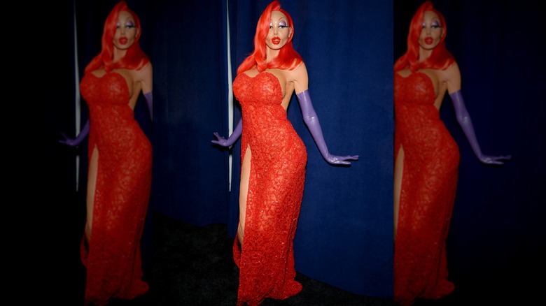 Heidi Klum wearing a Jessica Rabbit costume and posing in front of a purple curtain