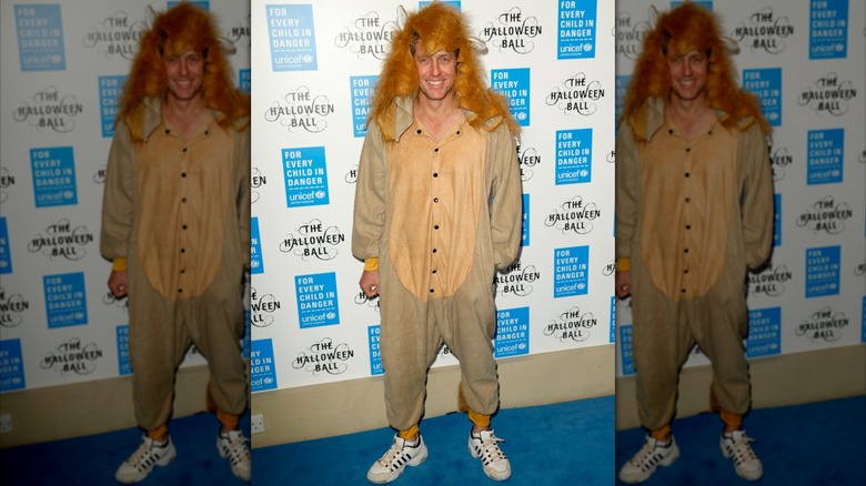 Hugh Grant wearing a lion costume and sneakers